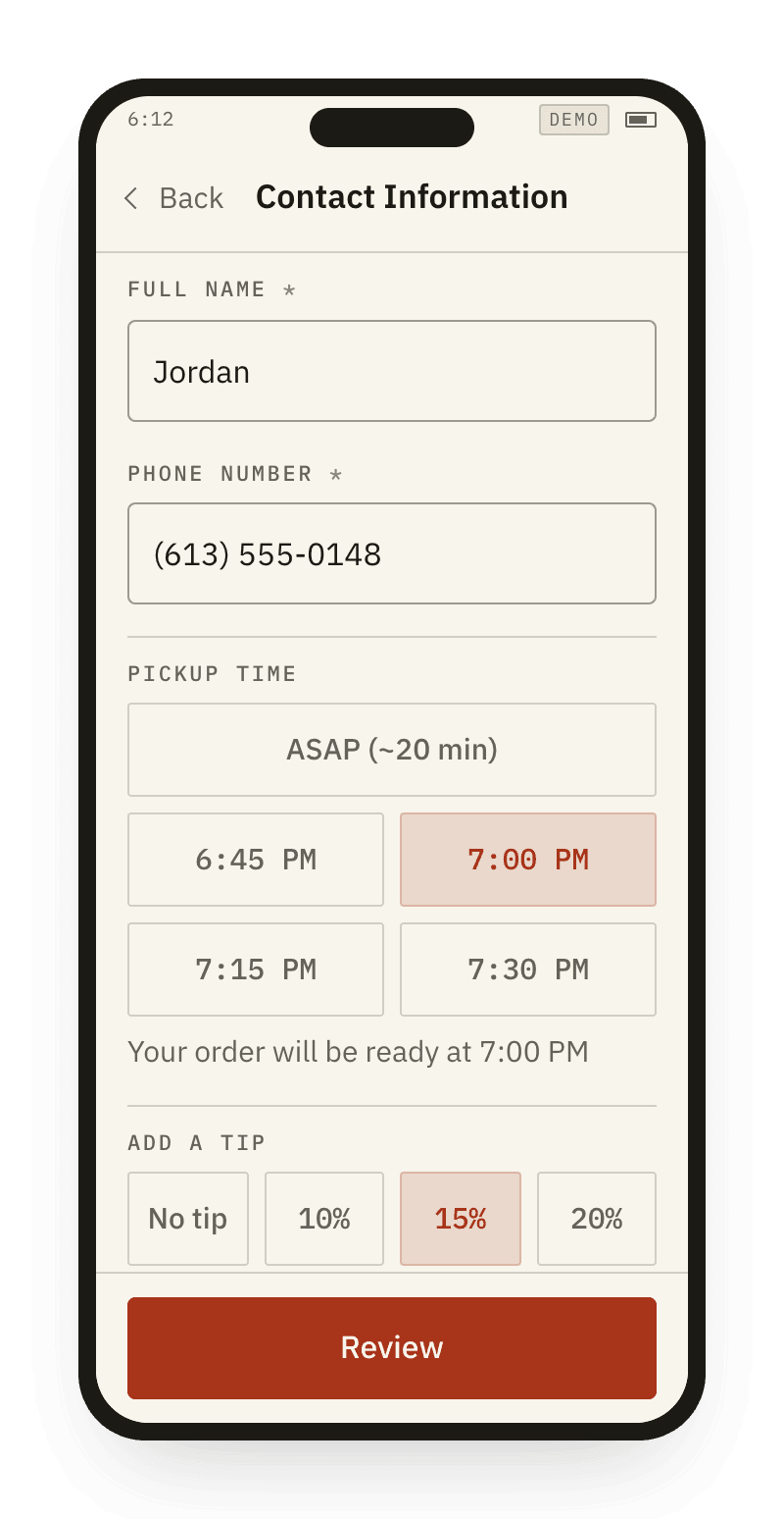 A phone at checkout with a pickup time chosen and a tip selected.